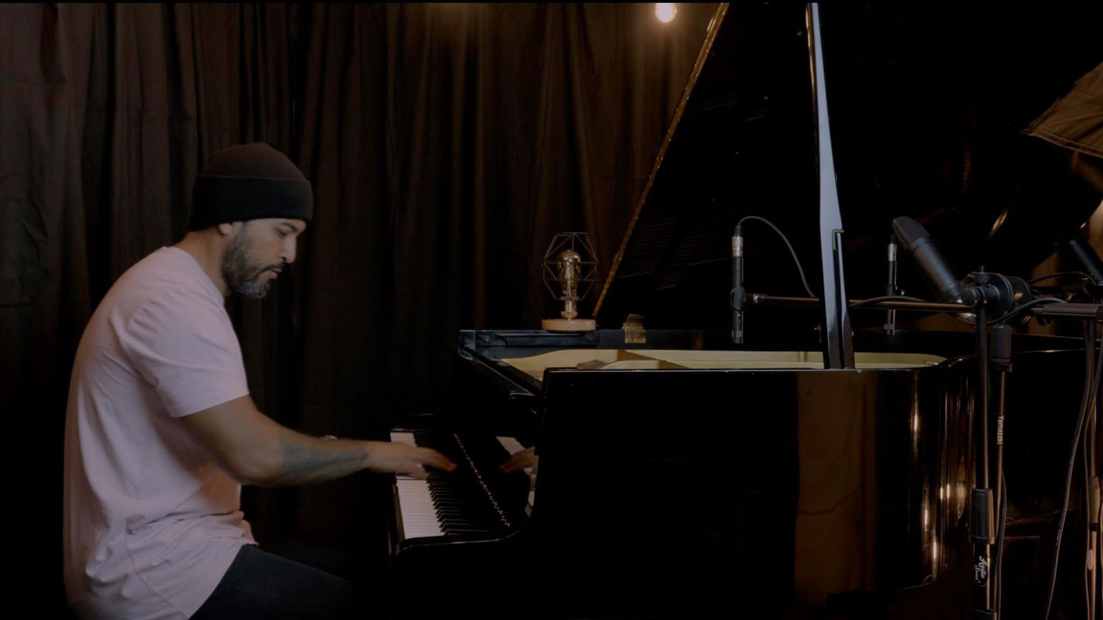 Carlos Maya playing piano during a recording session