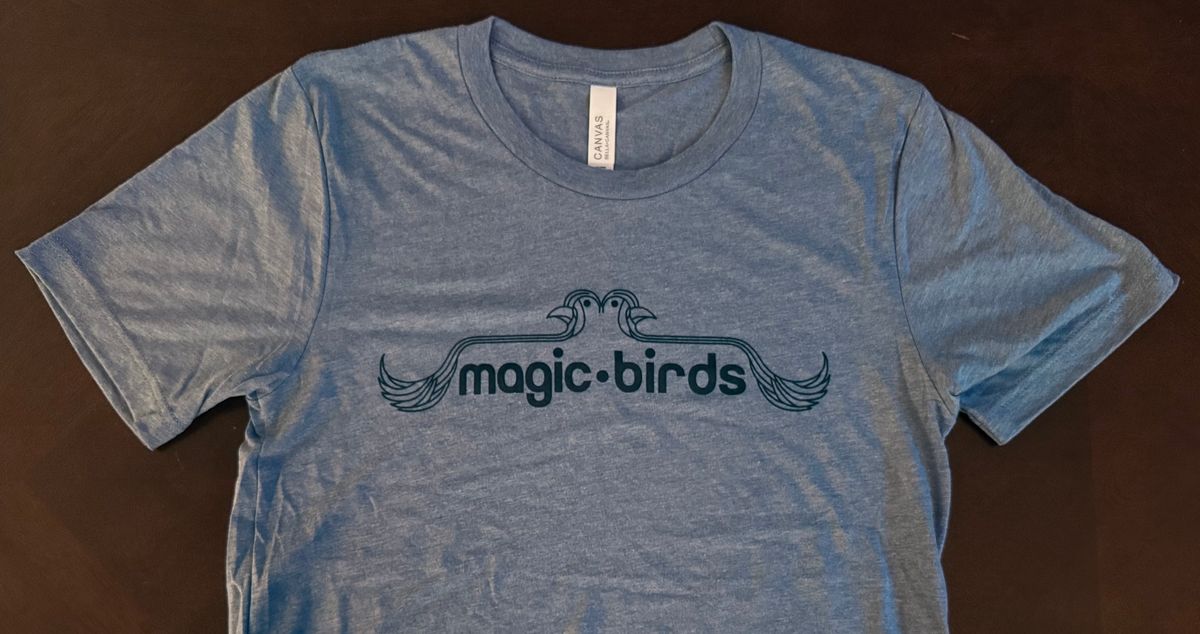 Magic Birds Logo on Blue T-Shirt