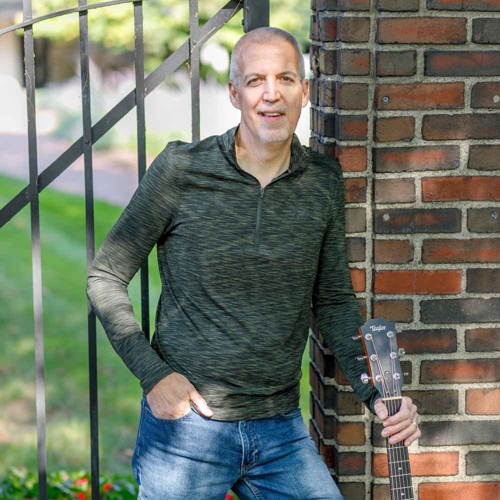 Mike Lucey standing at wrought iron gate