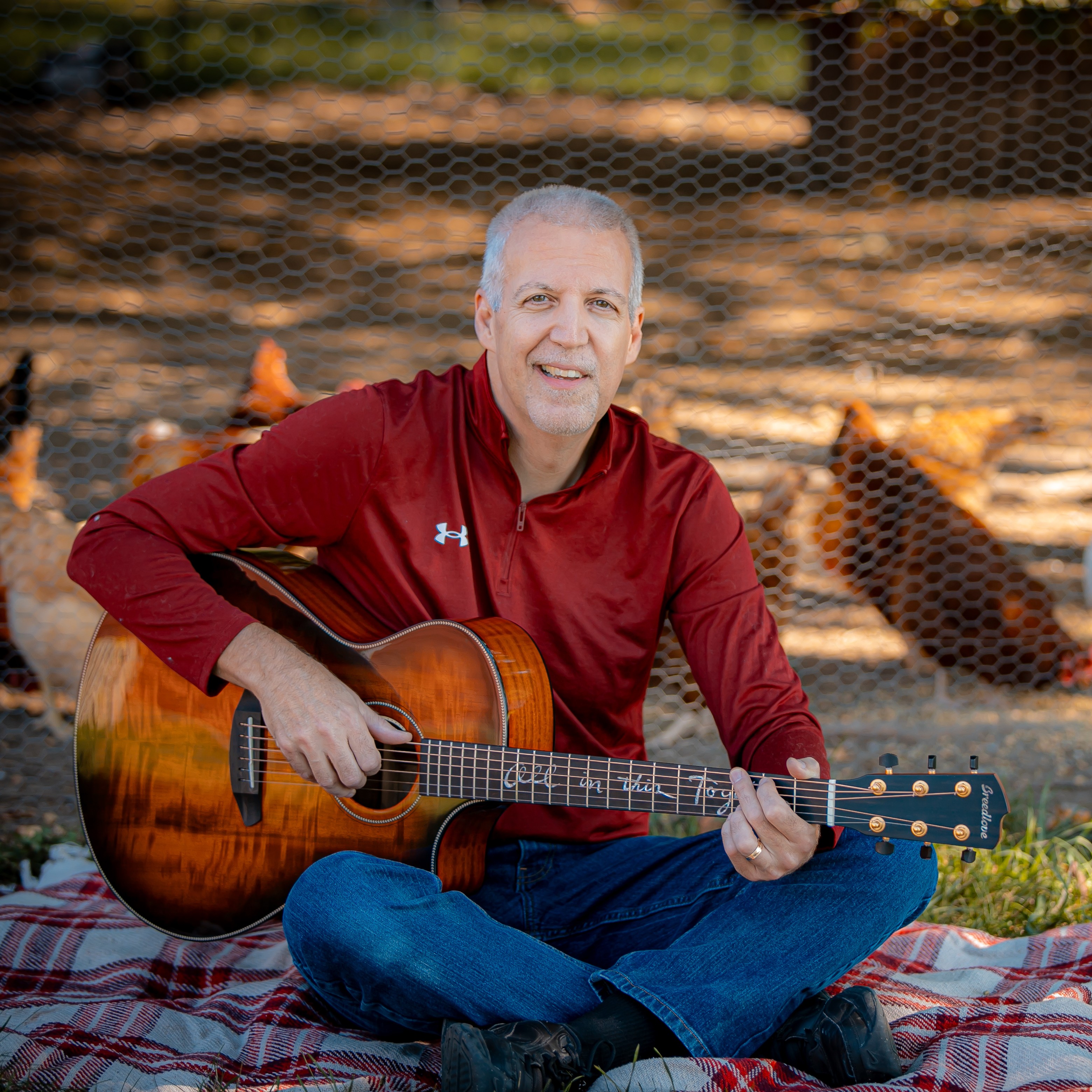 Mike Lucey Sitting on a Blanket with a Breedlove Acoustic