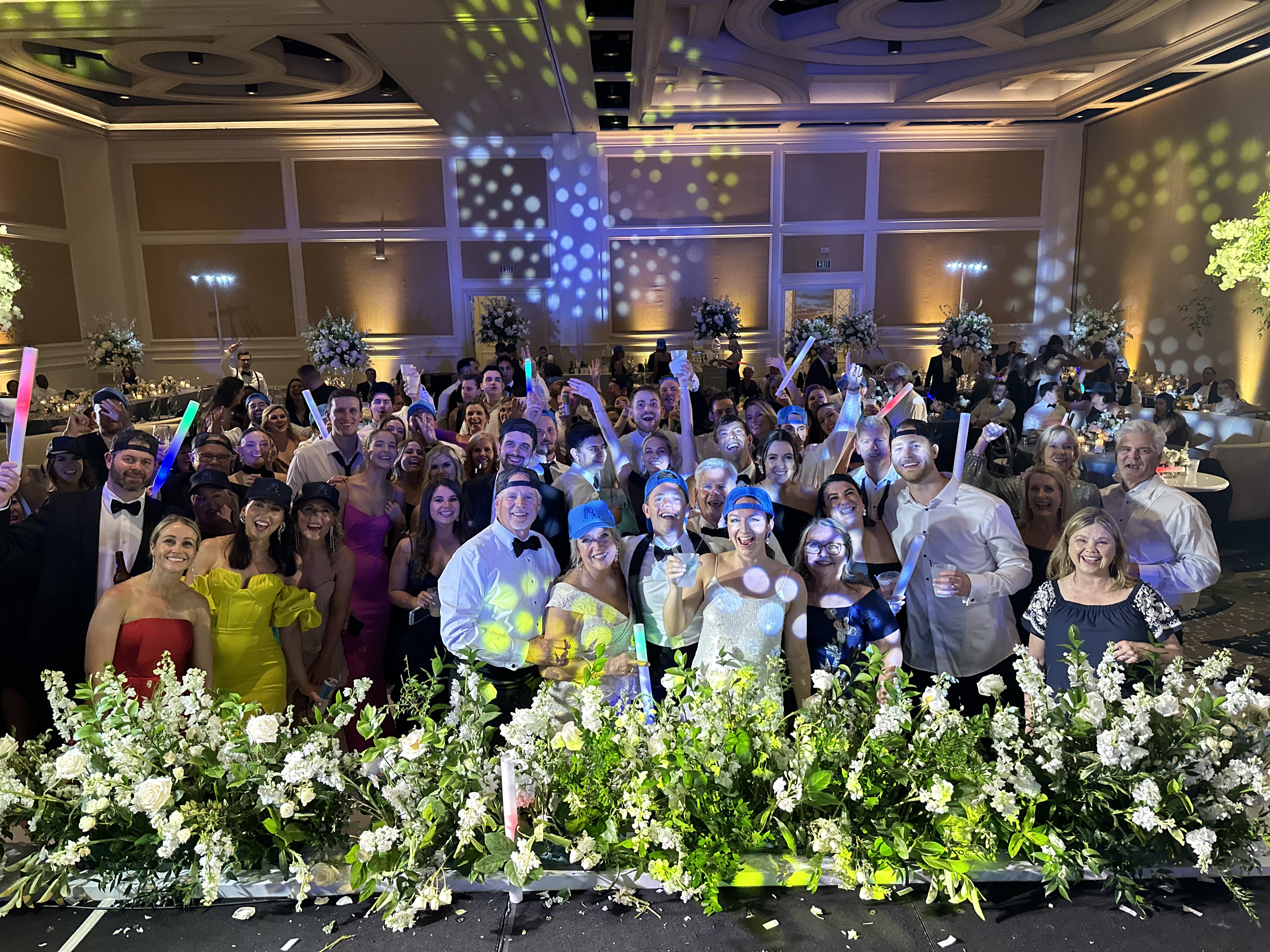 Packed ballroom party crowd with glow sticks at Ritz Carlton Orlando wedding