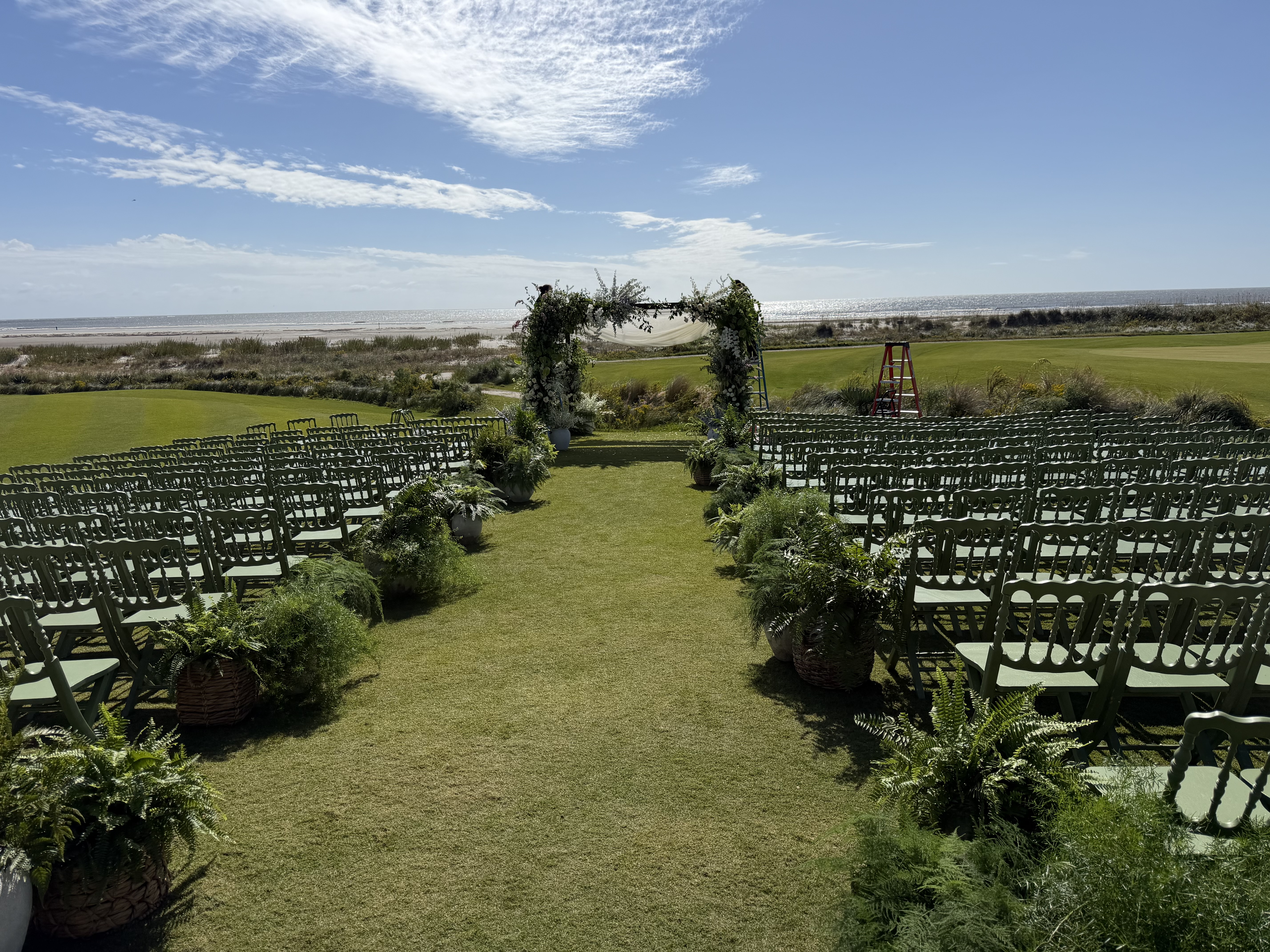 Oceanfront wedding ceremony setup with floral arch and Atlantic Ocean view at Kiawah Island