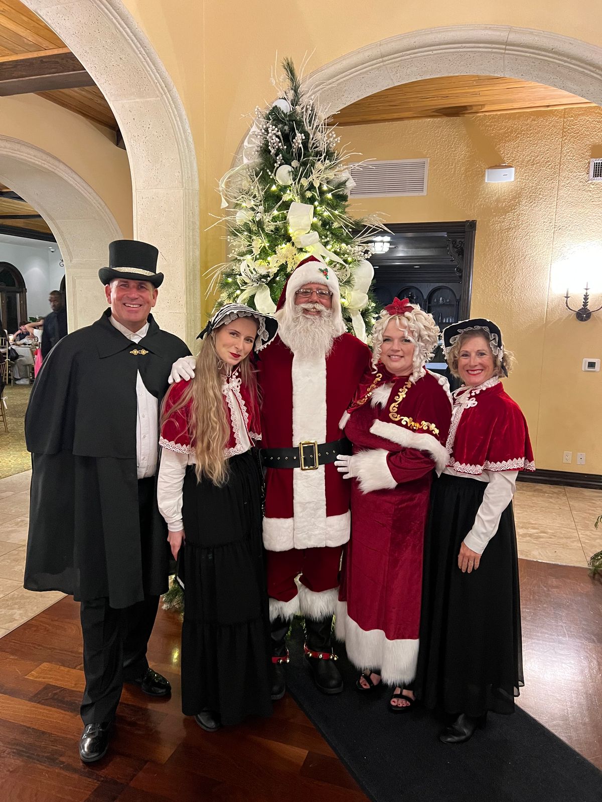 Holiday performers with Santa at a decorated event