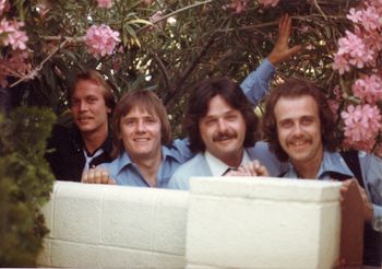 The only known photograph of this itineration of Hi-Jinx.
 Taken in the side yard of 1800 Franklin.  Mikey Mahoney is holding the Rhododendron flowers out of our faces with his left hand!  Photograph by Tom Rodak
