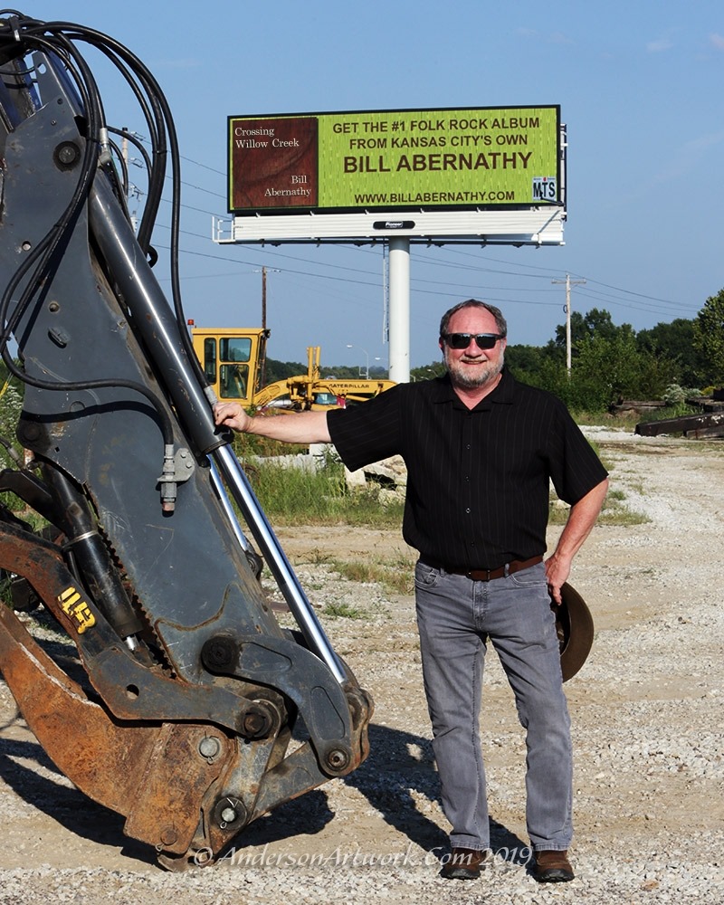 Bill beside his Crossing Willow Creek billboard