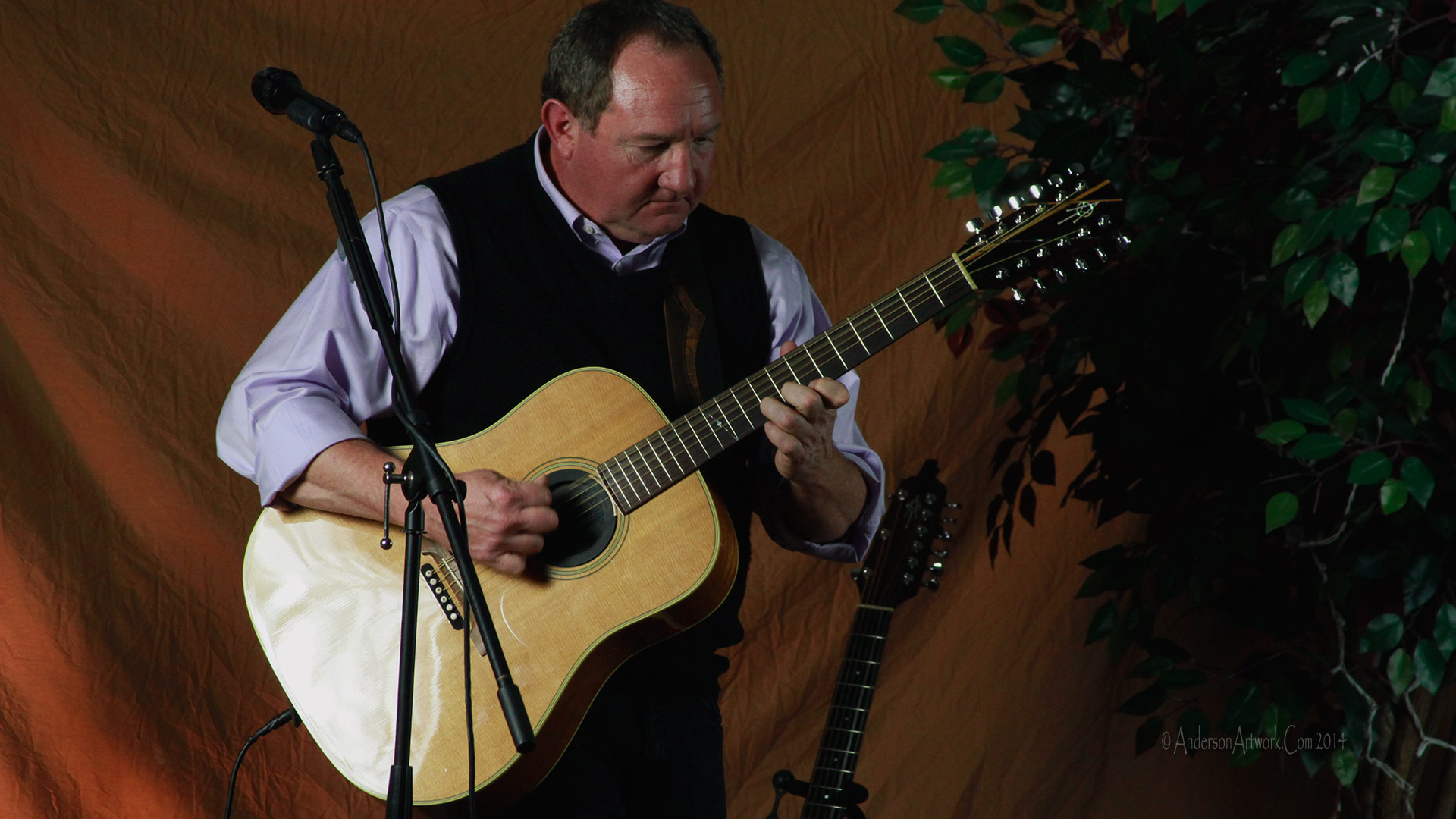 Bill playing guitar during an early show