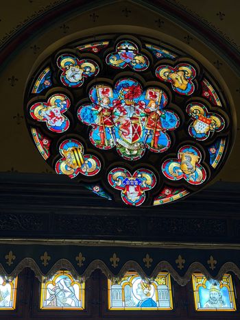 Schloss Drachenburg, Königswinter. An ornate stained-glass window. There is a lot of work in a little bit of light.
