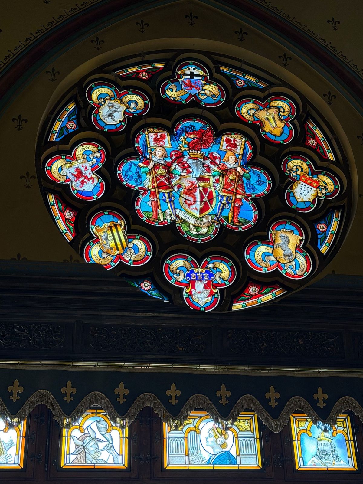 Schloss Drachenburg, Königswinter. A circular stained-glass window filled with color and intricate detail.