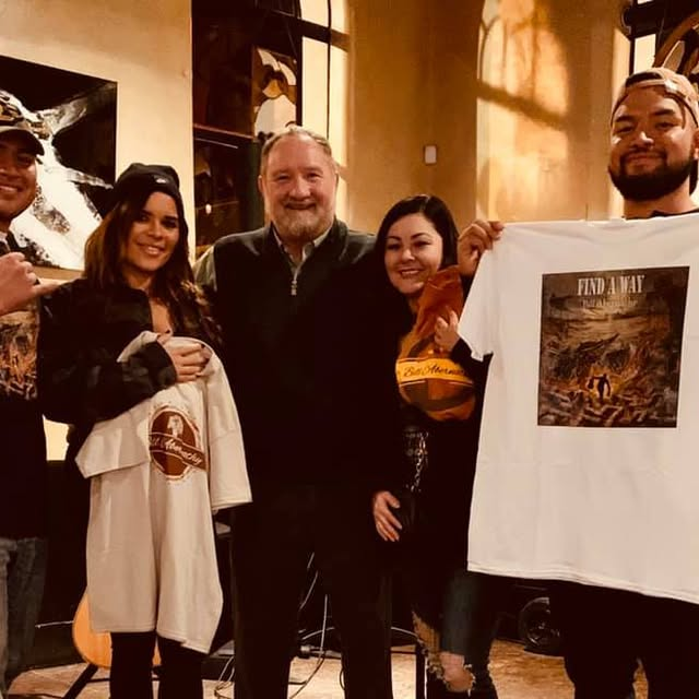 Bill with audience members holding Bill Abernathy shirts on tour