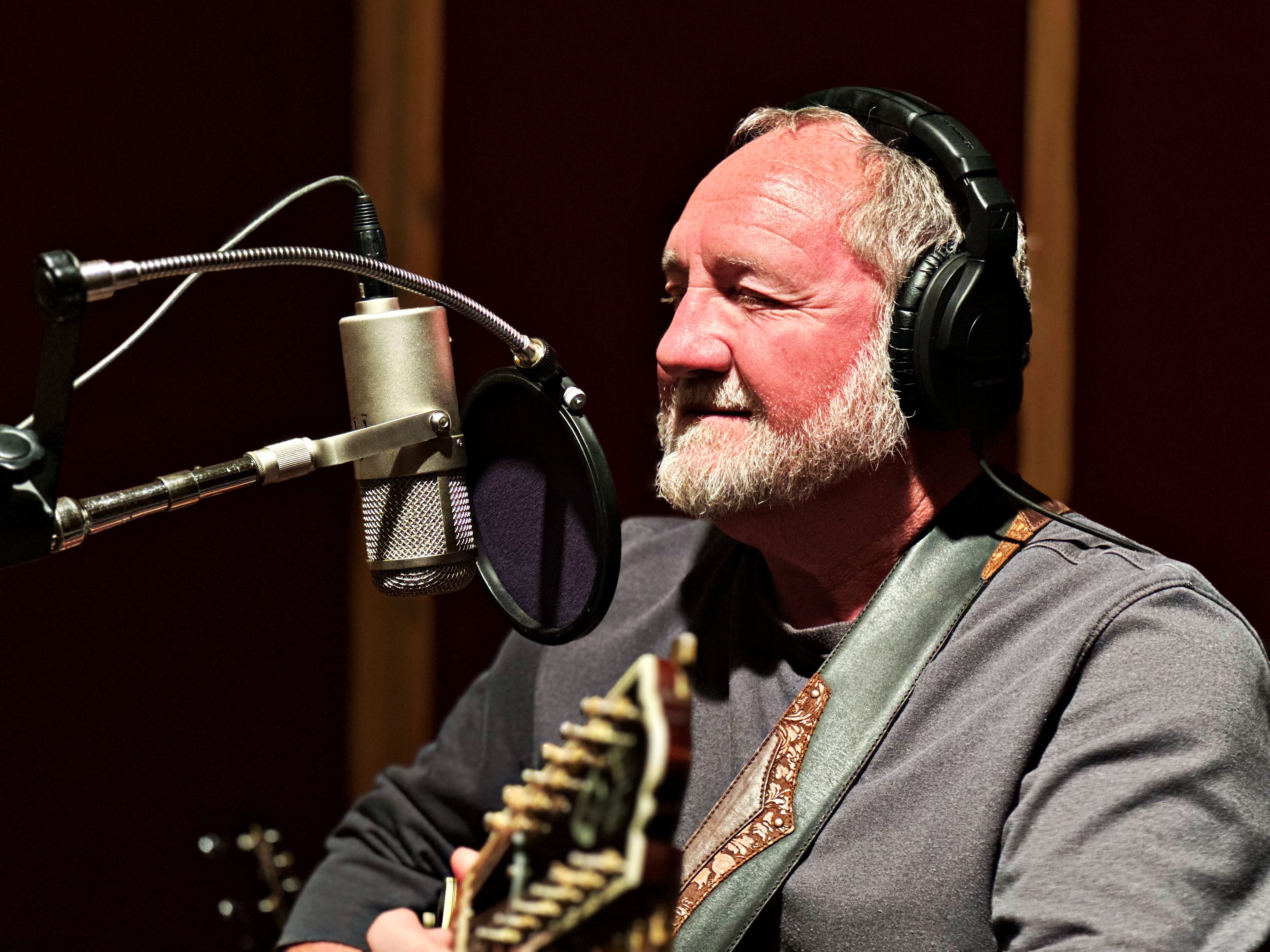 Bill recording MORE with headphones and microphone, 2023