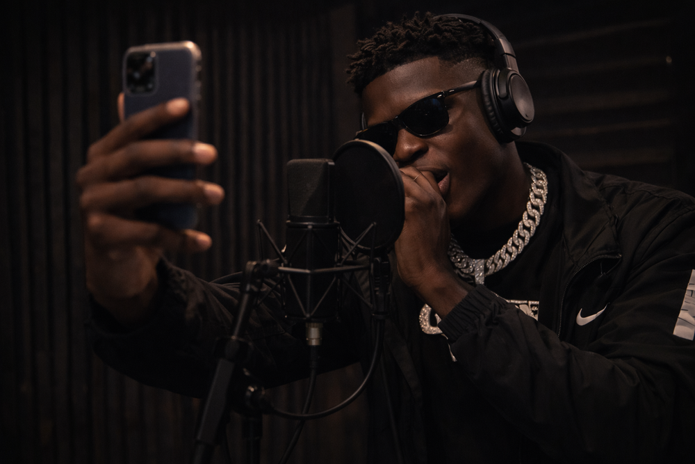 Social media manager working inside a professional recording studio managing music marketing and digital promotion
