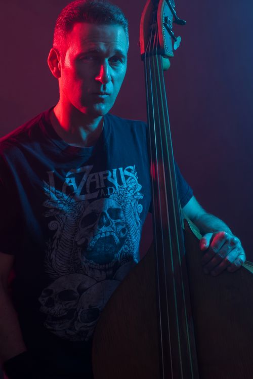 Portrait of bassist and composer Joe Belson holding  upright bass — Bay Area musician blending jazz, rock, and chamber music.