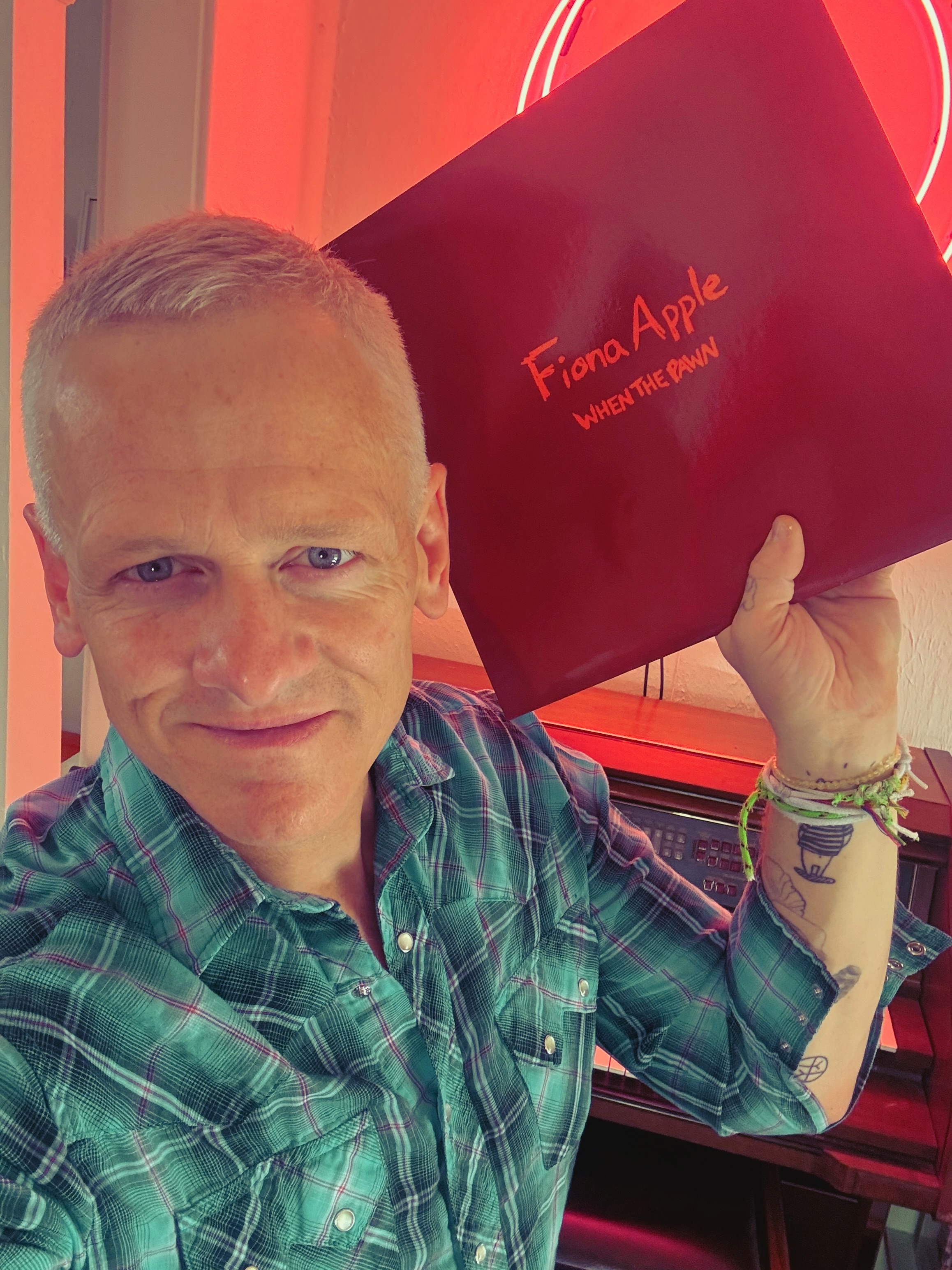 Patrick Tape Fleming Hold a copy of When the Pawn by Fiona Apple