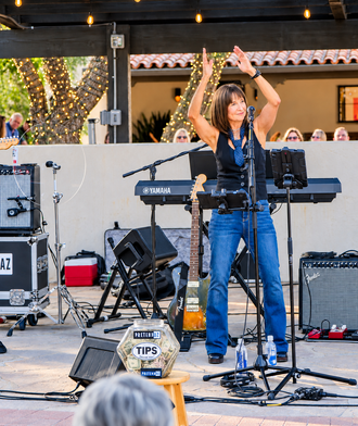 PretendAZ singer engaging the audience during a live 80s music performance