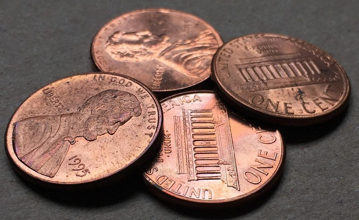 four pennies on a flat surface