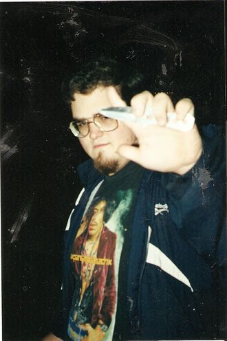 Jeff Atkinson, Jimi Hendrix shirt, Reebok jacket, holding pocket knife