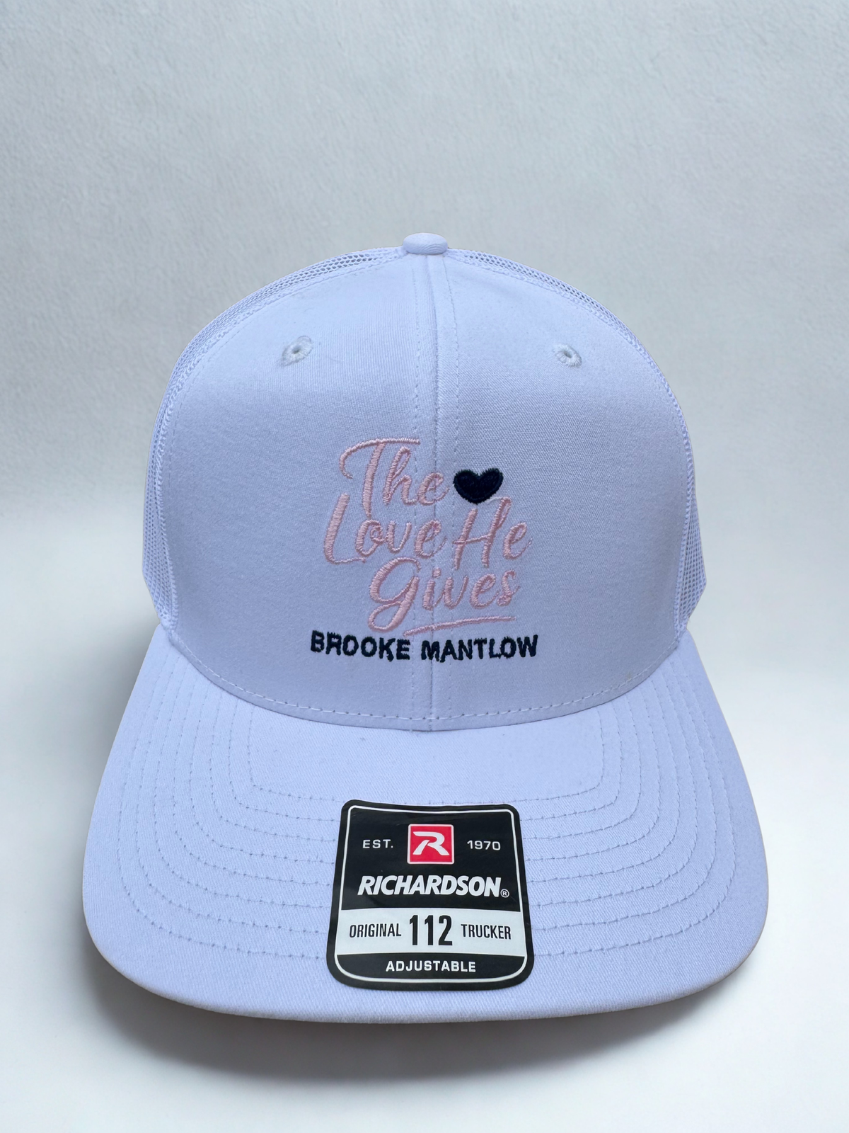The Love He Gives Trucker Hat