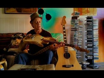 Larry showing off his homemade guitar which he used extensively on Nine Kinds Of Crazy.
