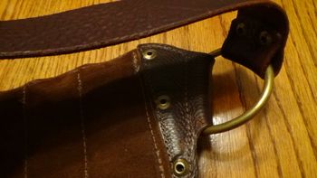 the underside of the bandolier next to the brass ring (notice the smoother underside)

