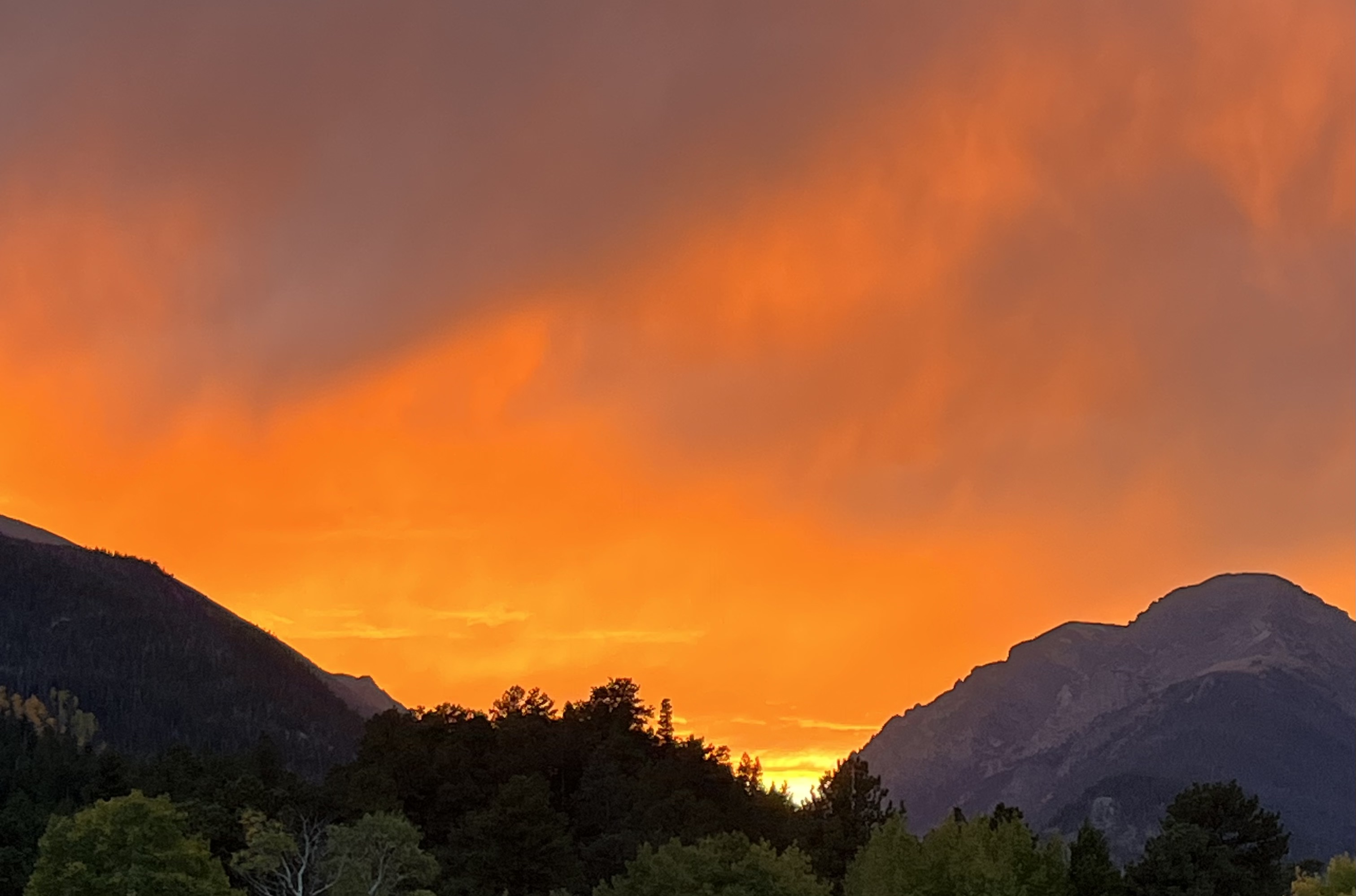 The setting sun lights the Rocky Mountains on fire.