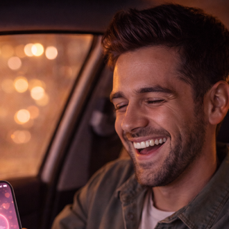 Happy man reacting to a Valentine’s Day custom song while sitting in his car