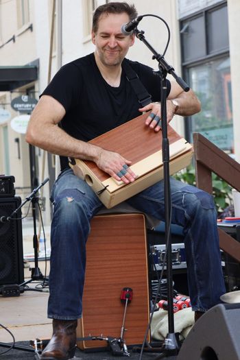 Playing a cajon and cajon tab made by Louson Drums, Celebrate Frederick, September 2023 ©Zorro Rojo Photography
