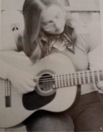 Marilyn in high school guitar club, trying to figure out a chord...or why boys act the way they do.
