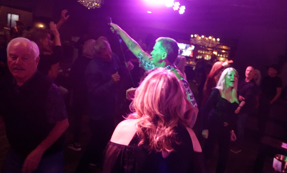 High-energy party band Funk Shui engaging a packed crowd to get the audience dancing at a live California event.