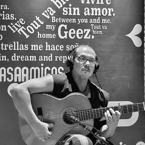 Shane playing in casa amigos, wearing headphones