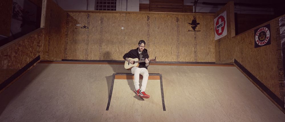 Matt Gisbrecht alternative pop singer songwriter plays guitar in a skatepark in Cleveland Ohio debuting a new acoustic indie pop song