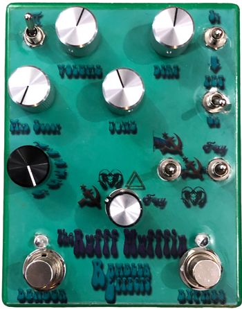 The Rufff Mufffin

The Rufff Mufffin recreates 3-4 versions of the classic fuzz box. Volume, Dirt, Tone and Mid Scoop knobs help sculpt the tone while 8 switches change components to make different version of the classic Big Muff (TM) circuits.
The Pi Switch engages the PI filter, 2 switches control the clipping, a 4-way Voice Switch selects the tone section from the Russian, Ram, Triangle, or Foxy Lady versions while 2 additional gain switches select between Russian, Civil War/Foxy, and Ram versions.  Lastly, a Bender switch removes the diode clipping for a bender-like fuzz.
