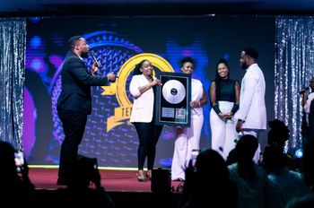 Bj'orn Pierre being presented with Album Plaque by Ten Strings Music Group at Mirror Man 2: The Concert
