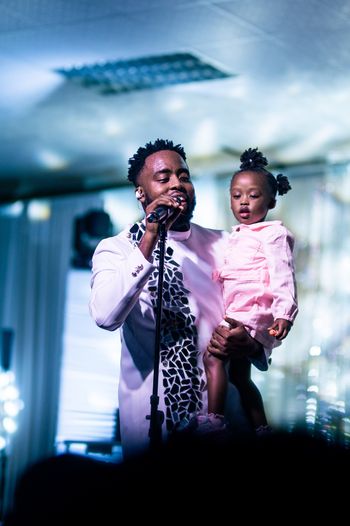 Bj'orn Pierre shares a moment with his daughter on stage at Mirror Man 2: The Concert
