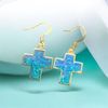 Iridescent blue cross earrings 
