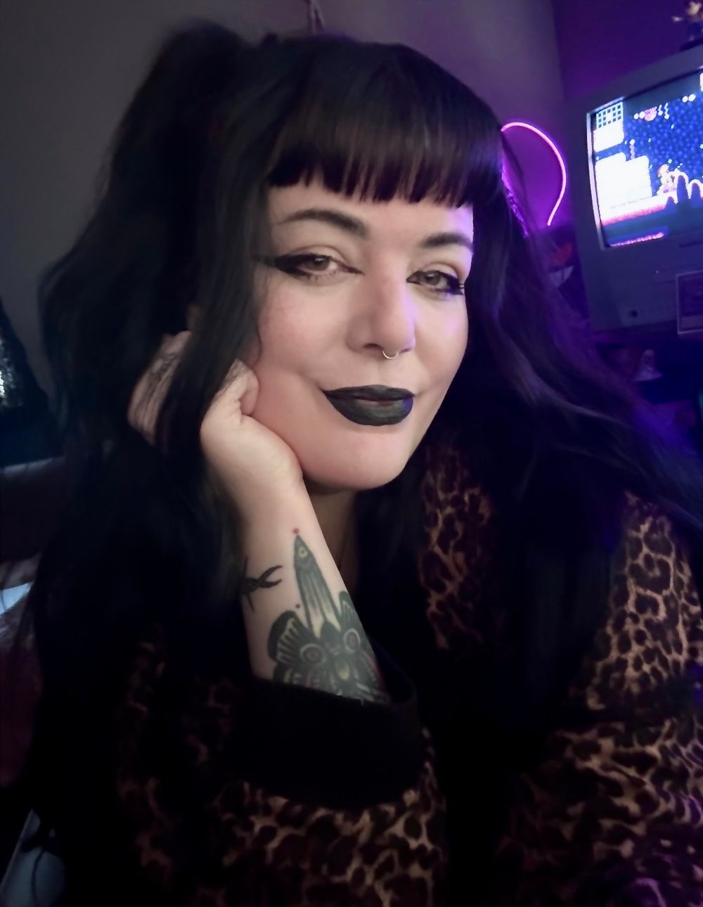 Goth girl portrait, black lipstick, next to a short bio about her, black eyeliner