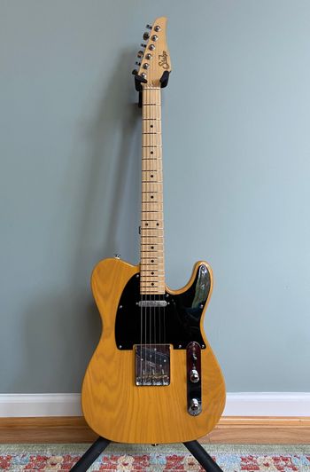 Suhr Classic T in Butterscotch Blonde — swamp ash body, maple neck, black pickguard. Boutique craftsmanship meets classic Tele DNA.
