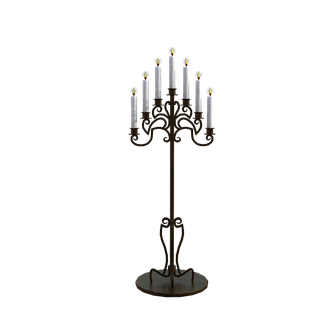 A gothic style floor standing candelabra with seven white candles lit