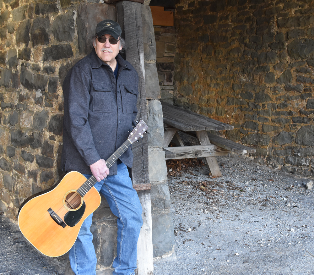 Ken Werner holding a guitar