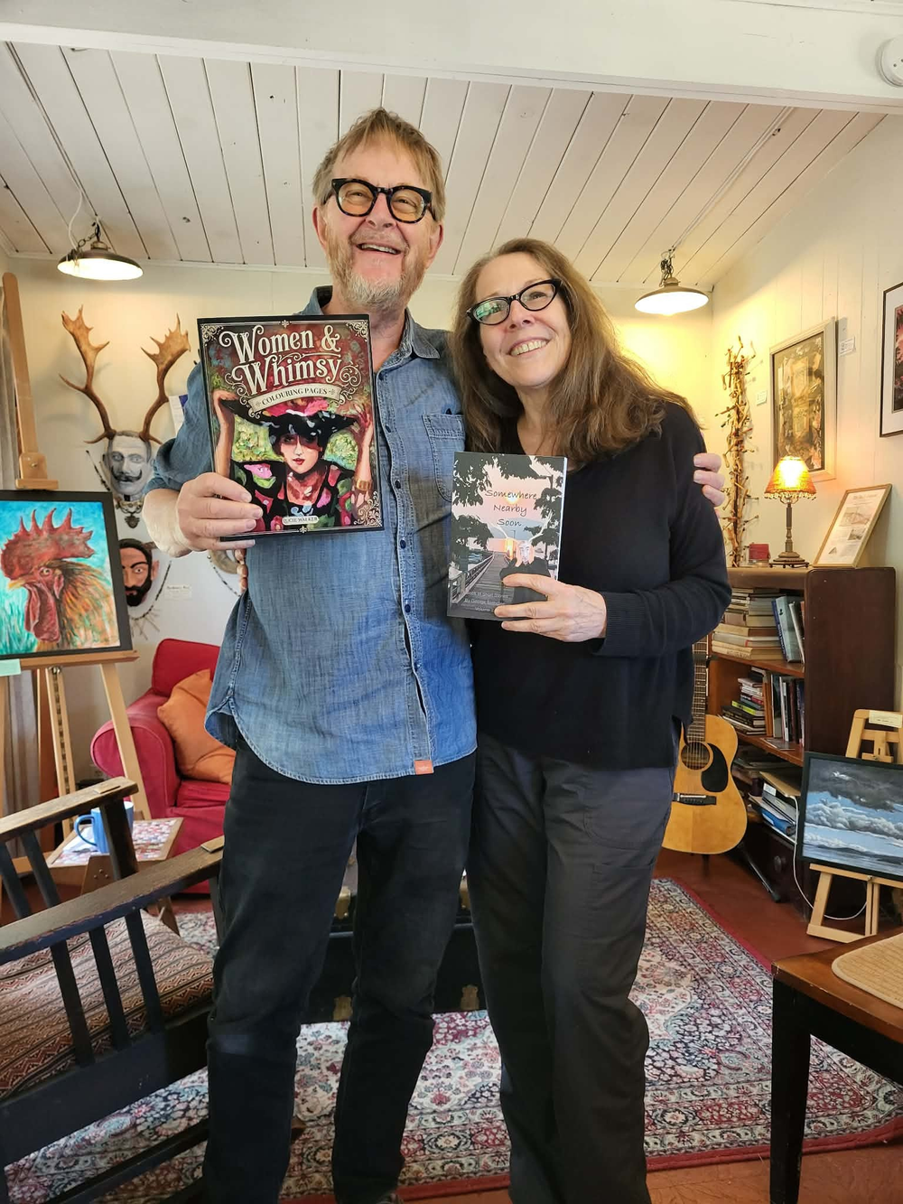 George Bathgate, holding Women & Whimsy, with me, Lucie Walker, holding his book, Somewhere Nearby Soon. 