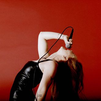Music artist singing against a vibrant red background