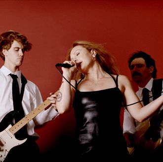 Music artist singing against a vibrant red background