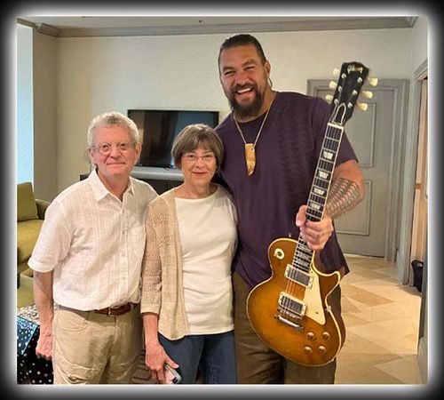 Guitarist Frets (Richard) and his wife with Jason Momoa holding the 1960 Les Paul Sunburst guitar "Blessing" from Season 1, Episode 8 ("The Holy Grail") of the docuseries On the Roam.