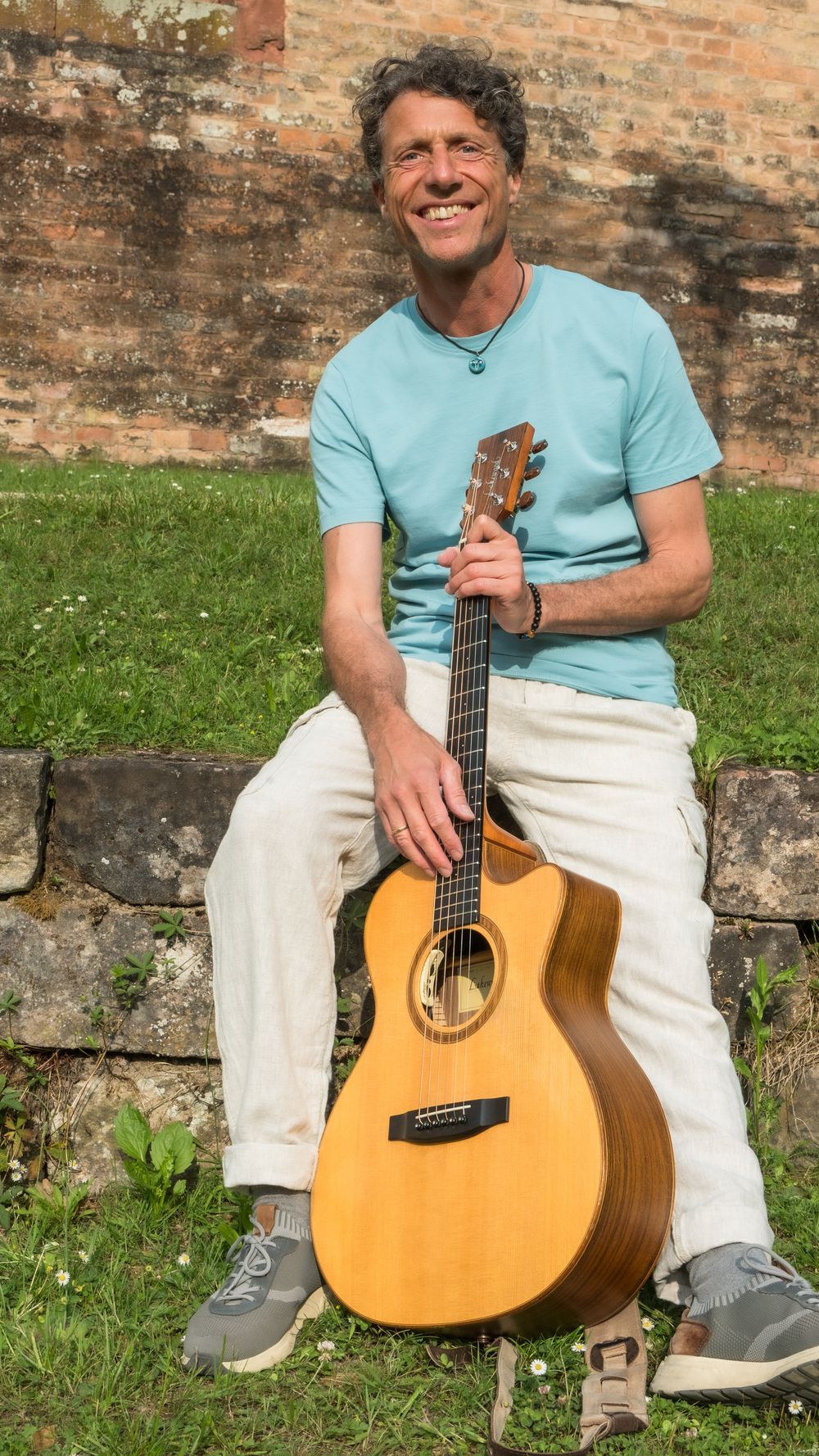 Der deutsch-italienische Singer Songwriter Marco Augusto mit Gitarre, die ihn immer wieder inspiriert, neue italienische Pop-Songs zu komponieren.