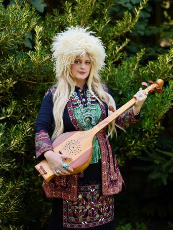 Kimberly Cofer promotional shot in traditional Khevsuretian attire and Chonguri in Mtskheta, Georgia. Photo credit: Nini Mamulaidze
