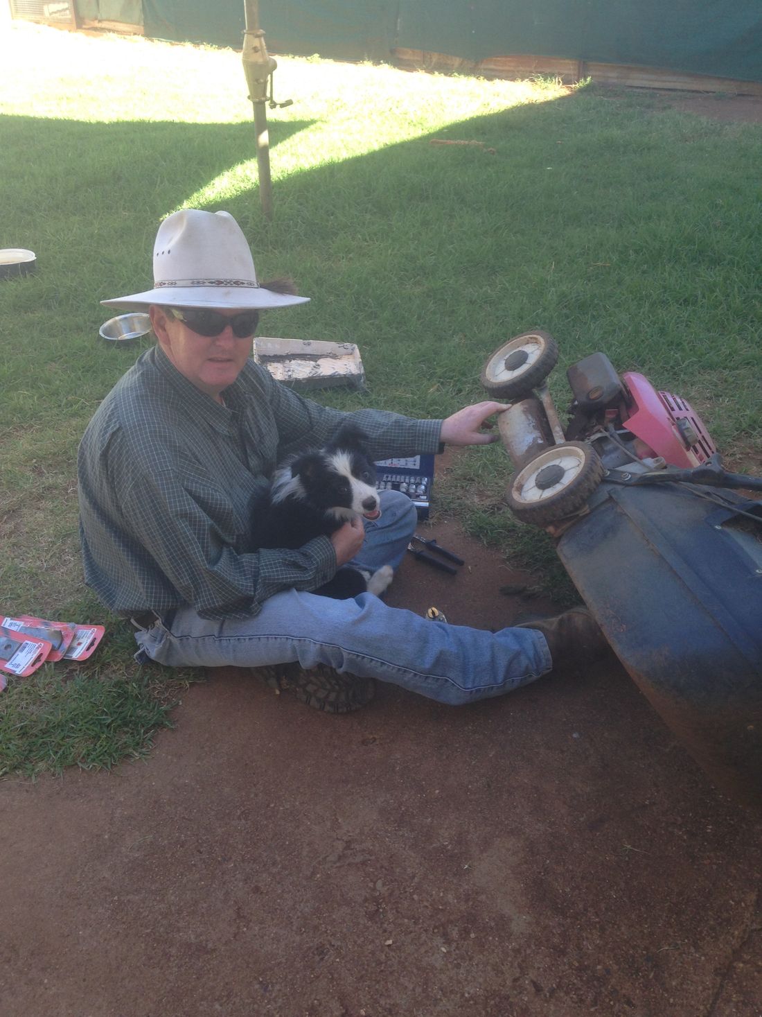 Lucy helping PaPa (Colin) fix the lawn mower
