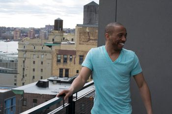 on the balcony staring at Manhattan

