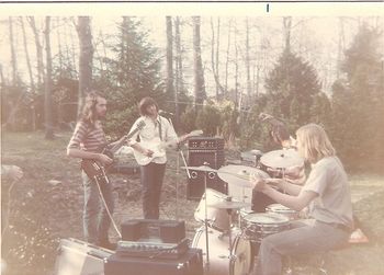 Lacewind, post-Michael, on an unseasonably warm day in the Spring of 1972. Here we find, left to right, yrs. truly (guitar), Russel Lloyd (?) (guitar), Alan St. Thomas (bass) and Scotty K. (drums). Barely visible at far left is the hand of Larry Gallat setting up his Farfisa. I was in full Allman Brothers mode at this point, working hard to nail "In Memory of Elizabeth Reed" and learning all I could about slide guitar from Honest Tom Pomposello at Kropotkin Records. I remember the first realization that I was hitting a wall with other musicians when neither Russel nor Alan could wrap their heads around the Liz Reed thing.
