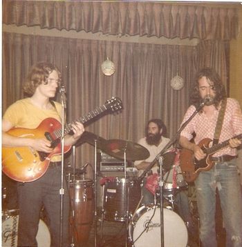 The Skydogs at the Massapequa Snake-Out, summer 1975, with David Noyes on guitar. This is the oldest photo I have of the 'dogs, and the only way I can verify the date is because I had the presence of mind to write it on the back of the picture. Otherwise, I freely confess that all dates hereafter regarding the Skydogs are subject to debate. Any clues to verify or correct any dates given will be greatly appreciated! That's David Noyes on the left giving me the hairy eyeball, and Bill Grillo on the drums.

