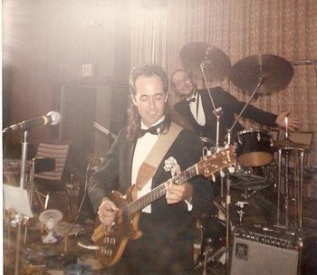 More club dating, about 1985. The rest of the band is on a break and I'm playing a ten-to-fifteen-minute set to keep the continuous music happening. Behind me is Ed Silver, who should be taking a break with the rest of the band. Instead, he's sitting in on drums. Ed normally played sax and clarinet and also hauled a Casio keyboard around to play on the rock tunes. As a drummer, he was a pretty good sax player.
