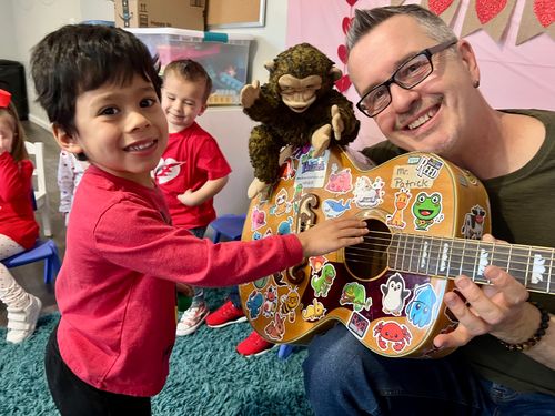 Music With Patrick with a child at a party.